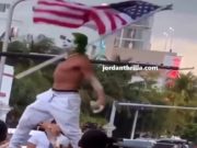 Man Dressed a Sting or Joker Yells "COVID is Over" at Miami Beach Spring Break While Standing On Cars