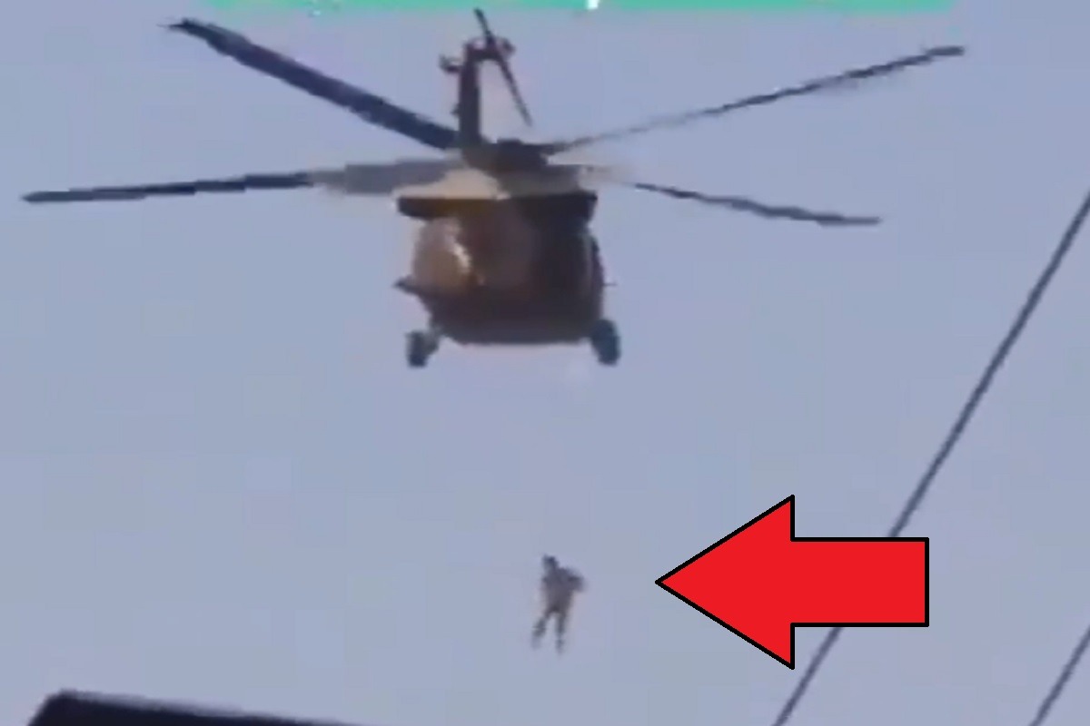 Sad Video Shows Taliban Using Blackhawk Helicopter To Hang Afghan Citizen in Mid-air. Footage showing Taliban dropping Afghan citizen from Blackhawk helicopter.