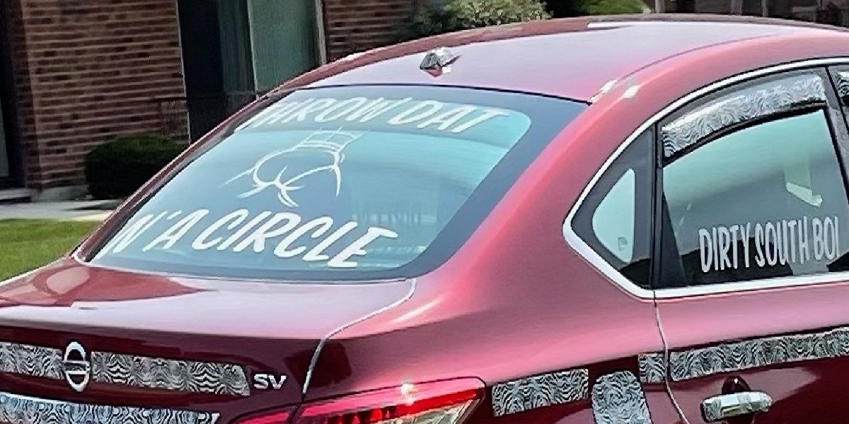 Throw Dat A** N'A Circle? Lil June Tacky Nissan Sentra With Camo Strips and 'Throw Dat A** N-A Circle' Slogan Goes Viral. Lil June license plate camo strip Nissan Sentra with 'Throw Dat A** N-A Circle' Slogan on tires.