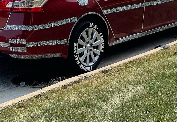Throw Dat A** N'A Circle? Lil June Tacky Nissan Sentra With Camo Strips and 'Throw Dat A** N-A Circle' Slogan Goes Viral. Lil June license plate camo strip Nissan Sentra with 'Throw Dat A** N-A Circle' Slogan on tires.