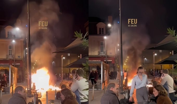 People in France Calmly Eating in Front Massive Protest Fire Sparks 'This is Fine' Meme Comparisons