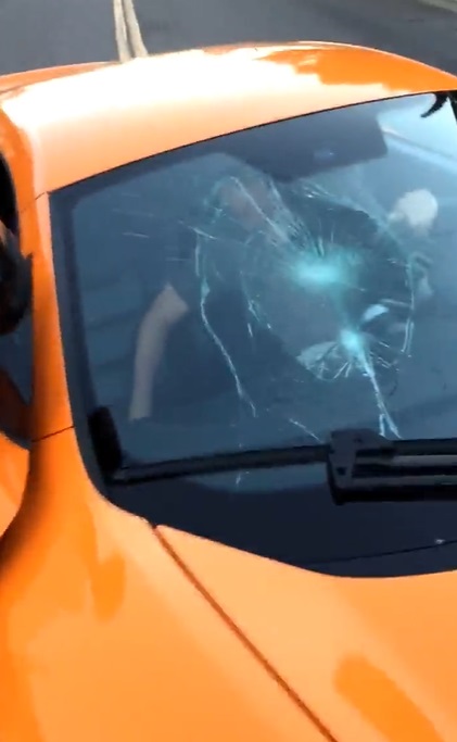 kid smashes window of $250k McLaren with skateboard aftermath photo