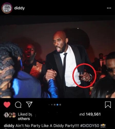 Kobe Bryant partying with P Diddy holding a glass of alcohol