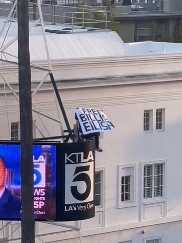 Man Holding 'Free Billie Eilish MK ULTRA' Sign Comes Down from KTLA Tower After Dropping Expensive Item