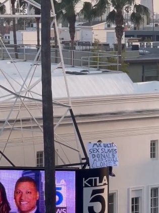 Why Was the KTLA Tower Man Holding a "Free Billie Eilish" and "MK ULTRA" Sign?