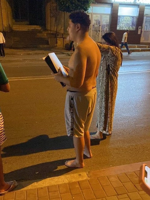 Shirtless Barefoot Man Holding His PS5 After Morocco Earthquakes