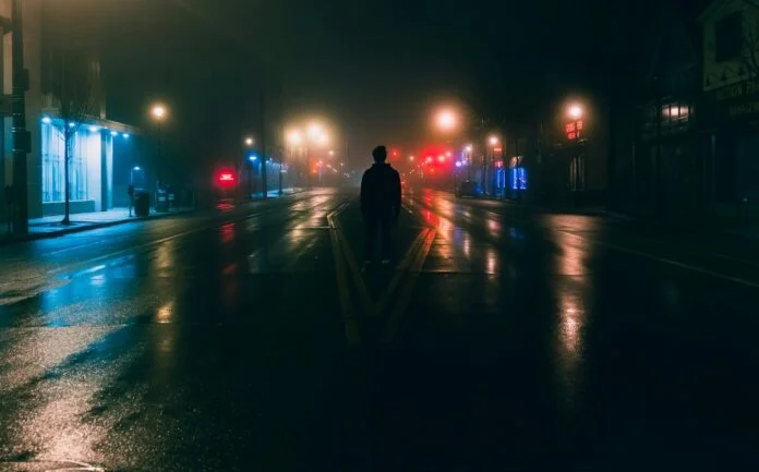 man-standing-in-street-at-night