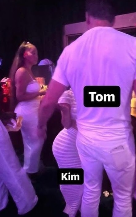 Tom Brady standing next to Kim Kardashian at Michael Rubin's All White Party