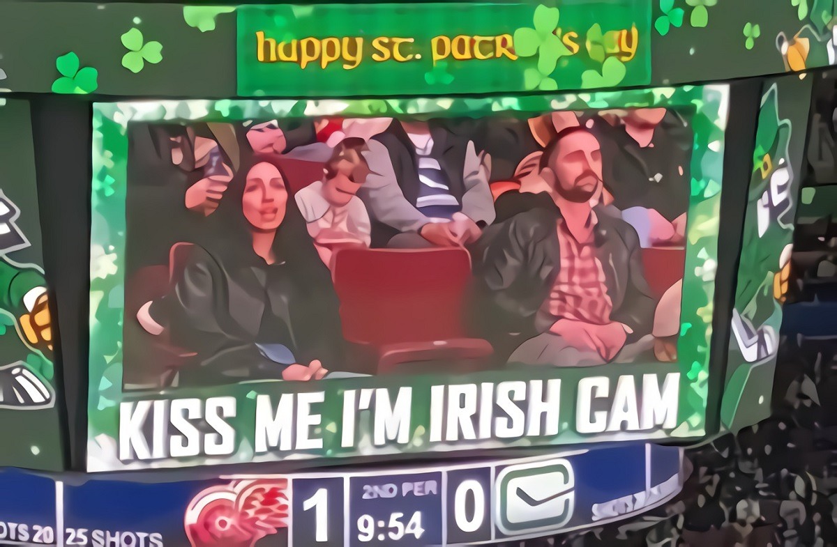 Cheating Woman kissing another man during kiss cam at Vancouver Canucks Hockey game.